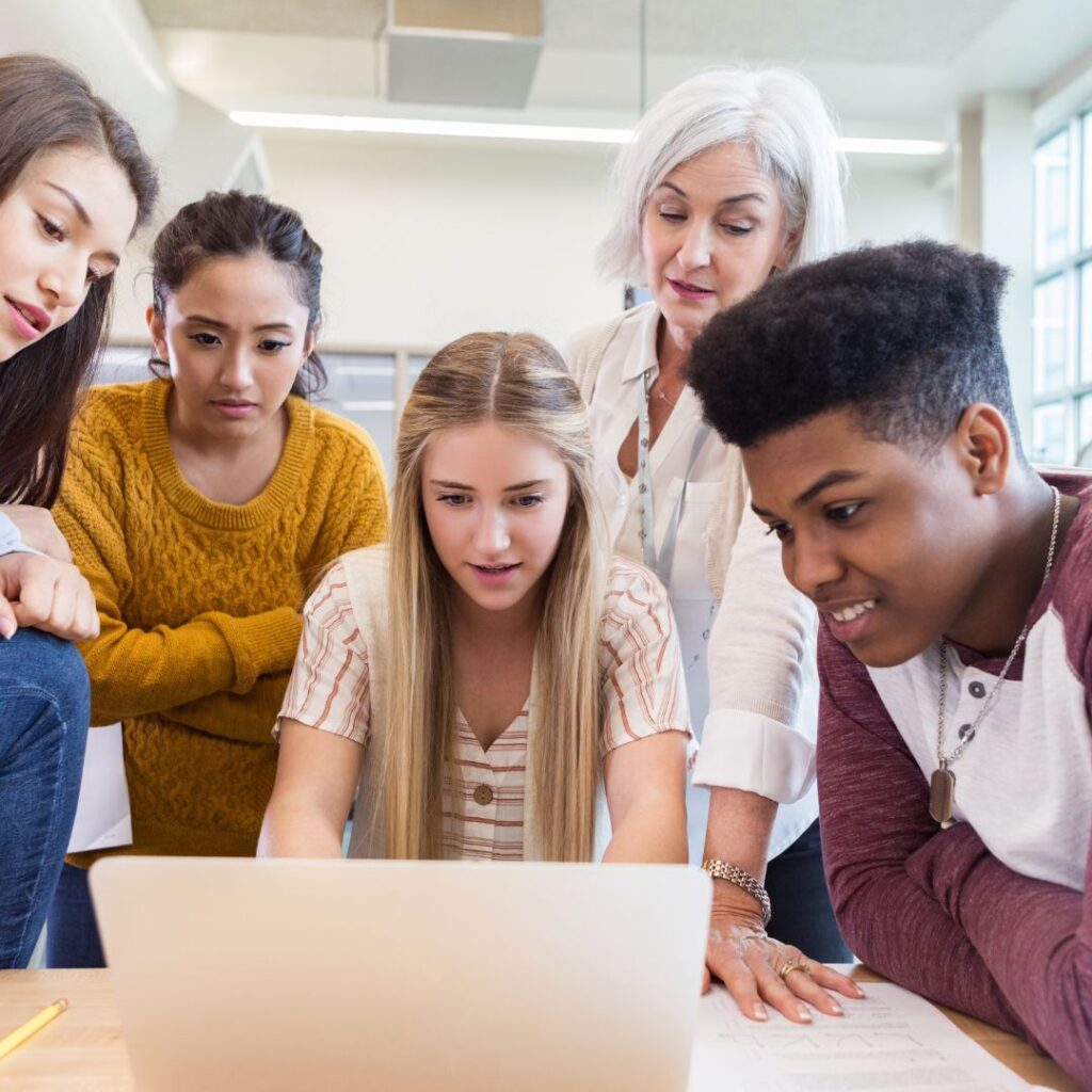 highschoolers gathered around computer