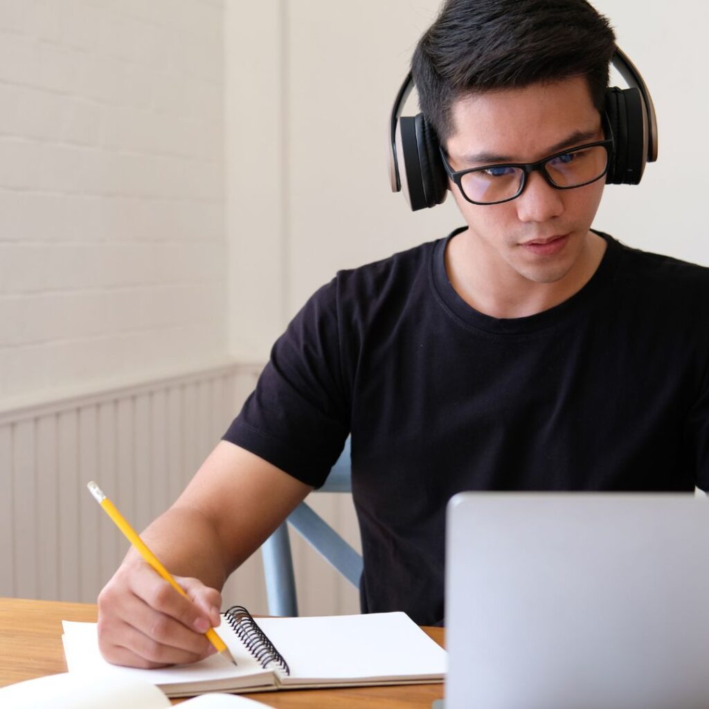 student on laptop writing