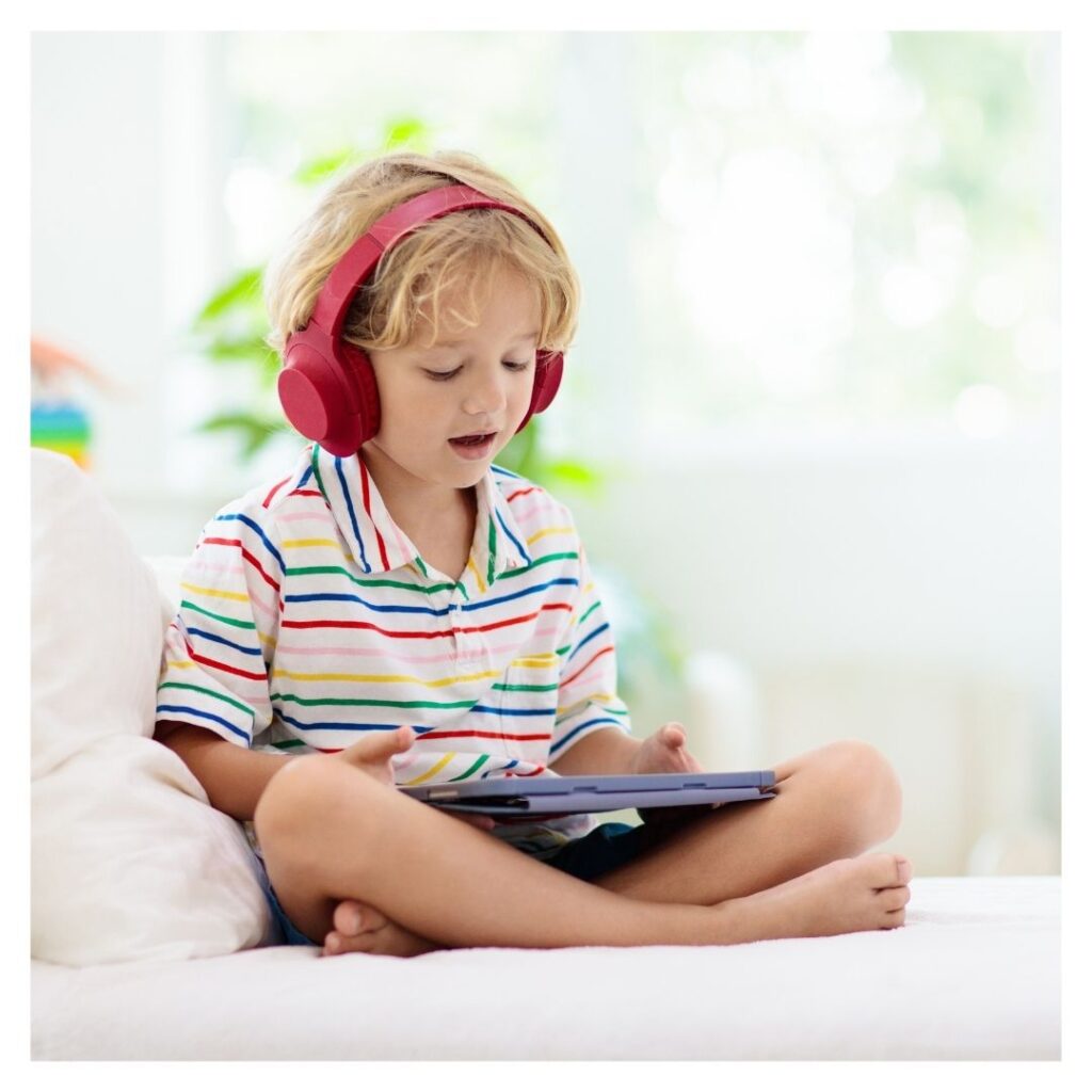 little boy usnig tablet with headphones