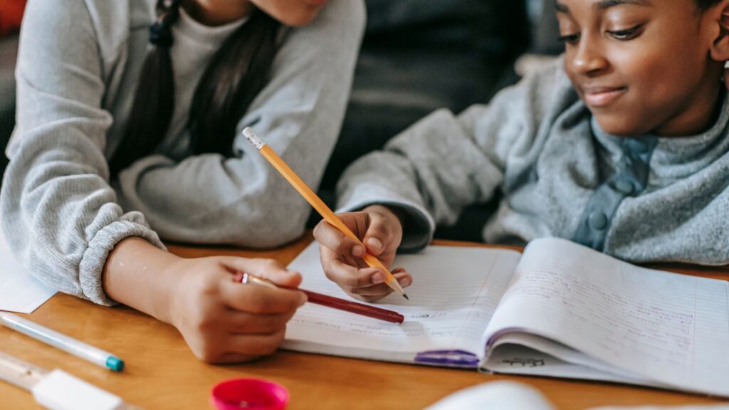 parent working with child on a writing lesson