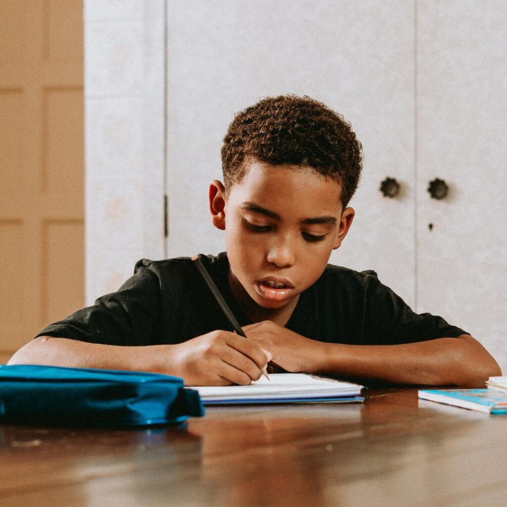 boy focusing on writing