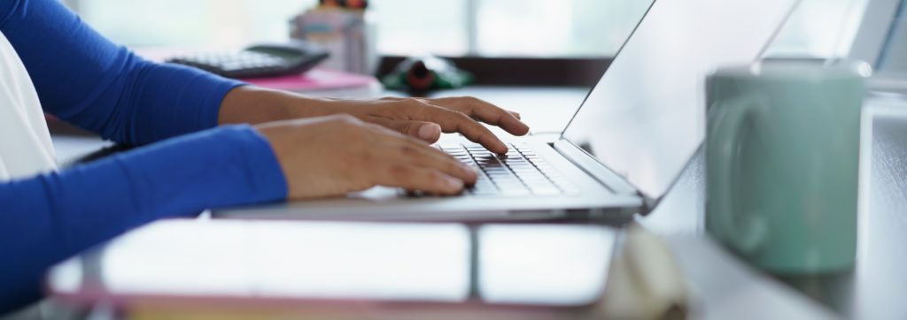 homeschool student writing on a computer for scoring service