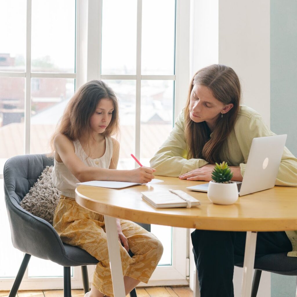 A child and parent doing homeschool together