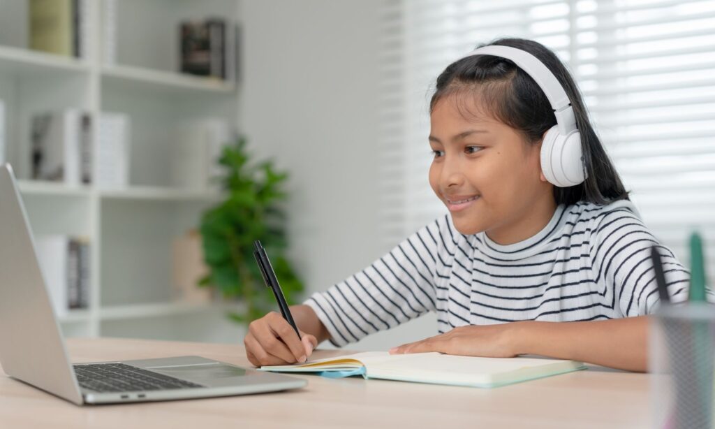 preteen working on laptop