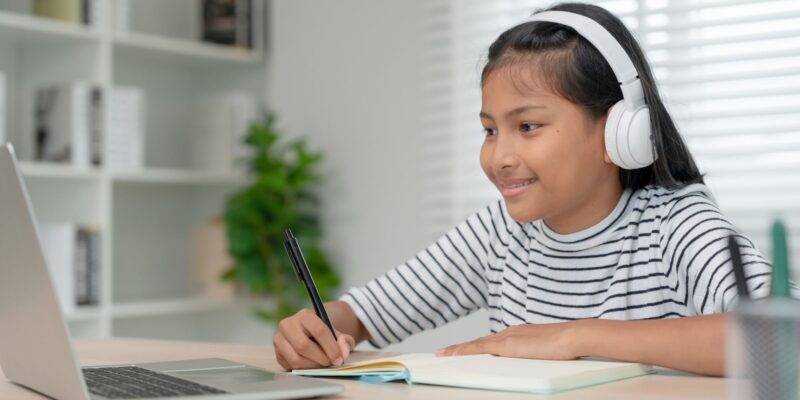 preteen working on laptop