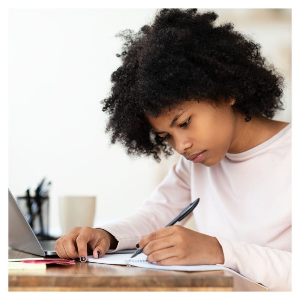 girl writing on notebook