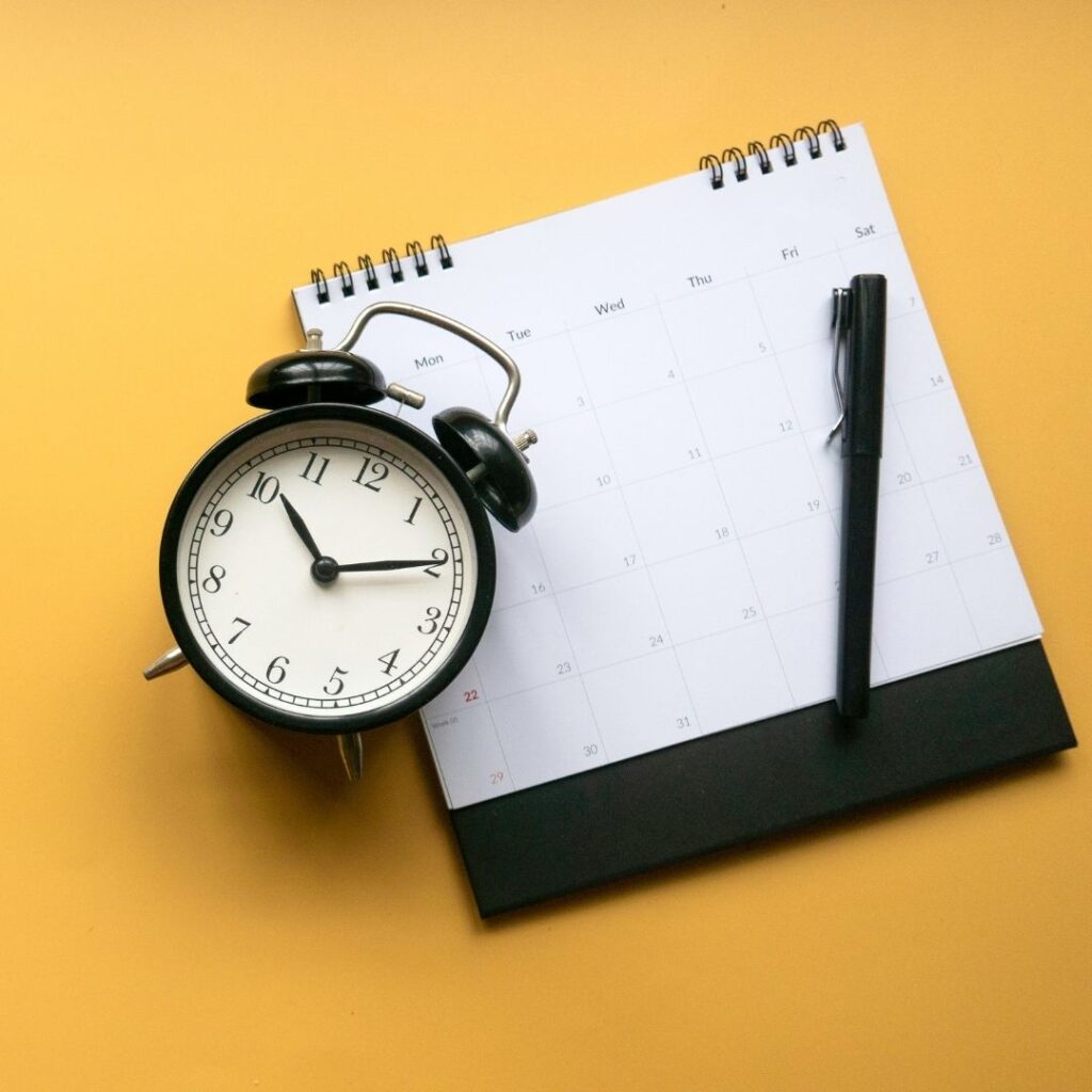 clock and calendar sit on a table