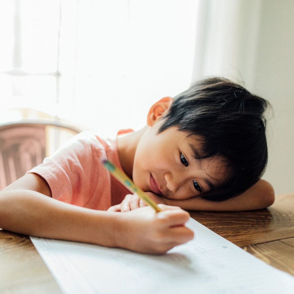 A boy completing homeschool work