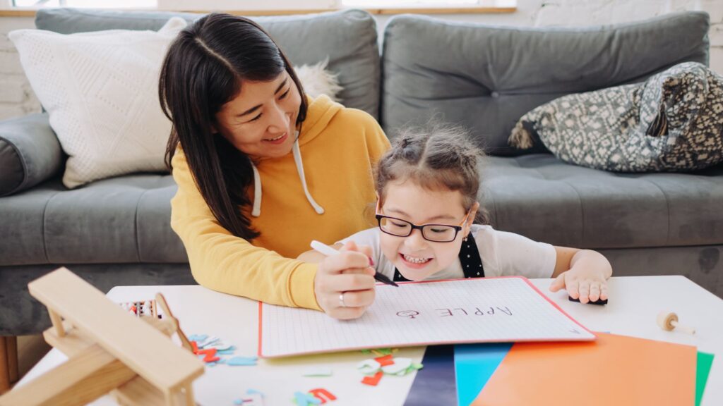 A child and parent doing homeschool together