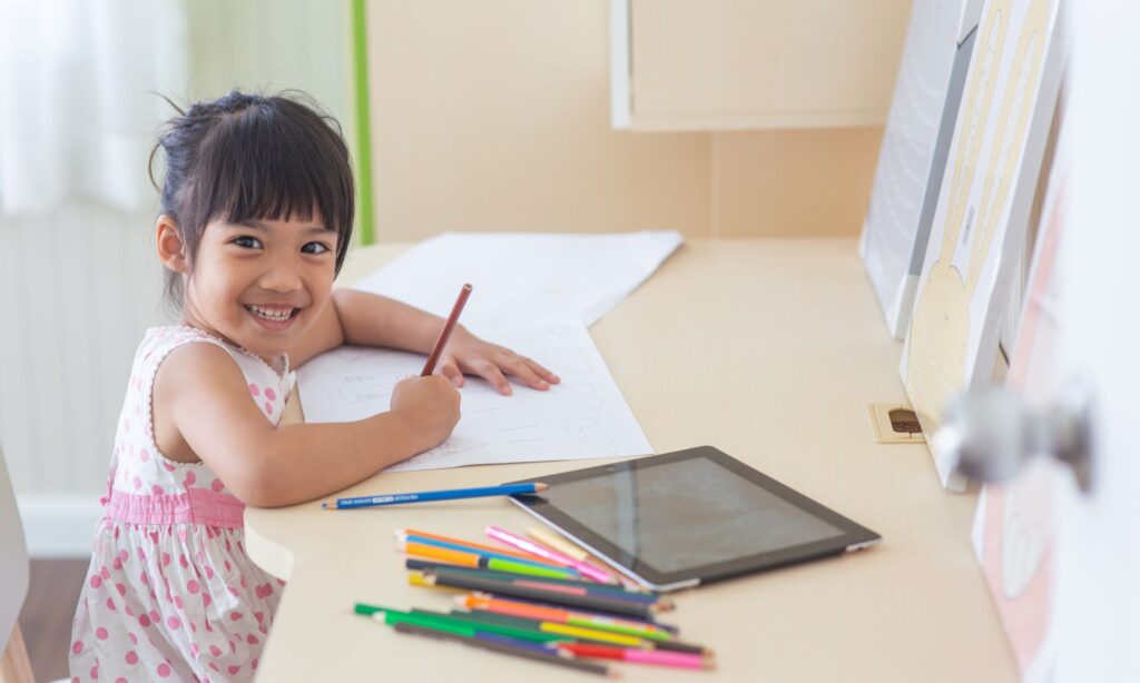 a girl writing at her desk at home