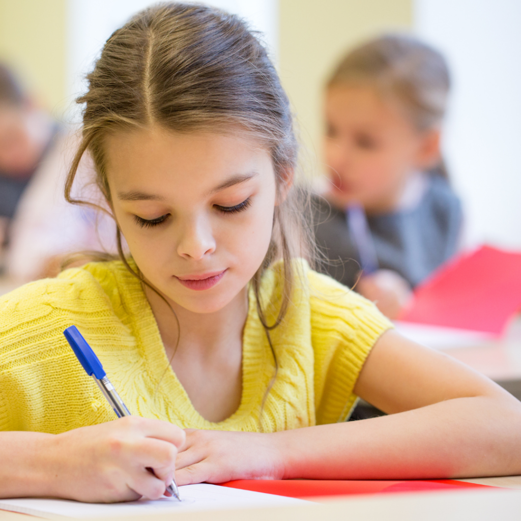 a girl writing with a mechanical pencil in a notebook